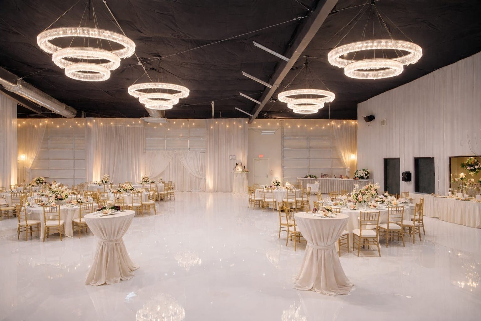 The main hall set for a banquet, chandeliers lit